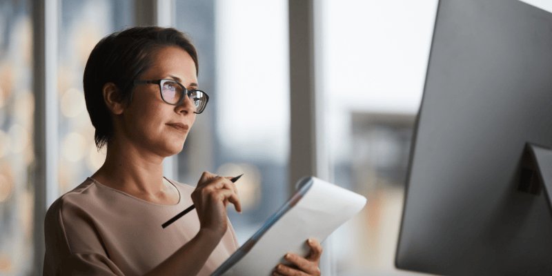 HR professional using software to create and manage employee handbook.